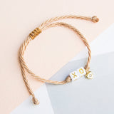 Pulseras Hilo Nudo - "XO" Besos y abrazos con corazoncito dorado